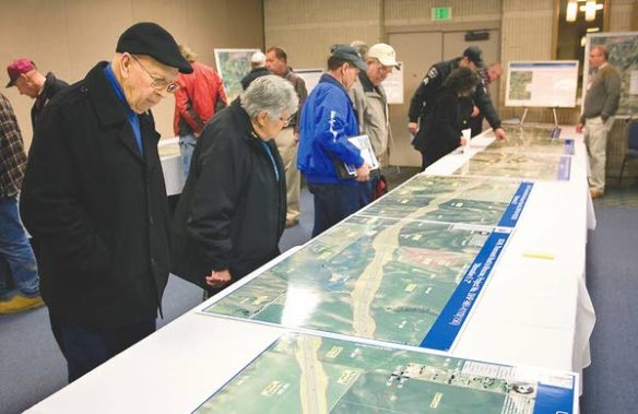 Bruce and Colleen Bumgarner, left, look at maps of proposed routes for the U.S. Highway 95 Thorncreek Road to Moscow Project during an Idaho Transportation Department hearing at the Best Western Plus University Inn in Moscow on Wednesday (Moscow-Pullman Daily News/Geoff Crimmins photo).