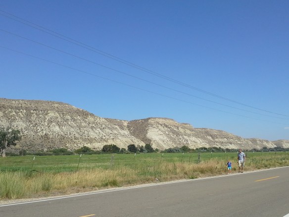 Across Highway 52 to the north, working ranches, community irrigation canals, and distantly recognizable sandstone cliffs and bluffs lie in close proximity to the directionally drilled and potentially fracked Smoke Ranch natural gas well, within a river confluence and wetlands floodplain.